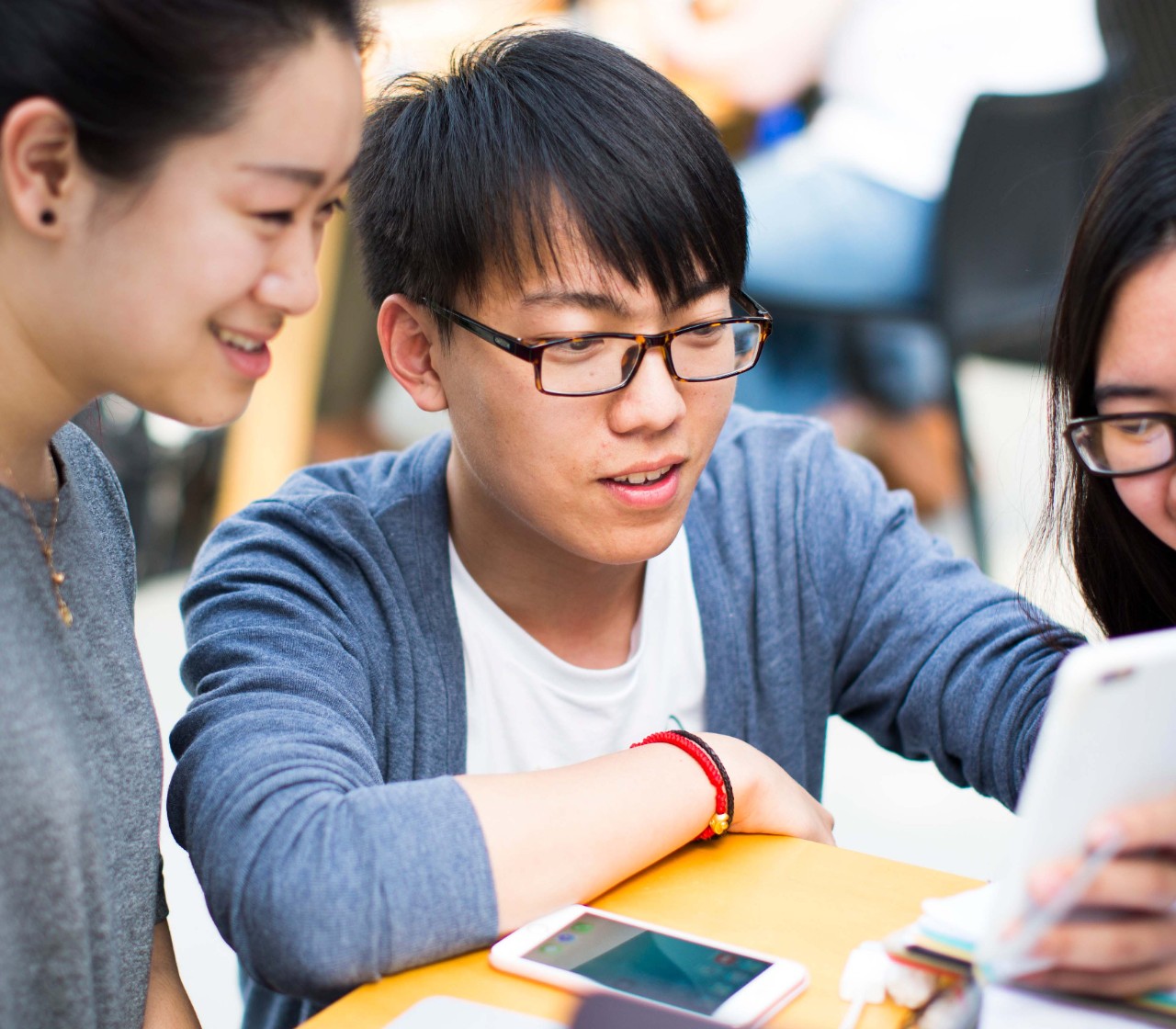 Students looking at information on a mobile phone